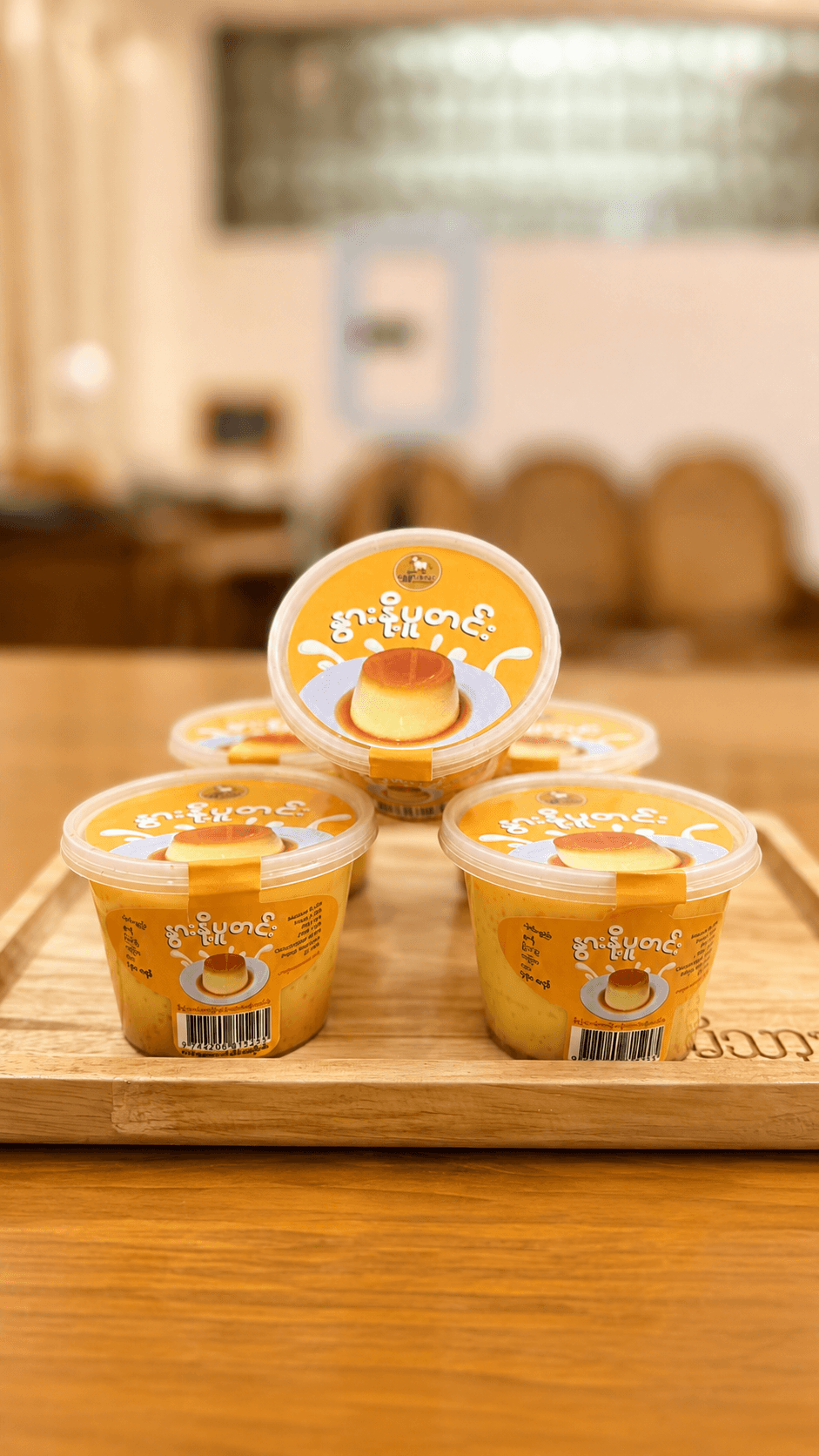 Three Shwe Nwar Lay Milk Pudding cups on a tray